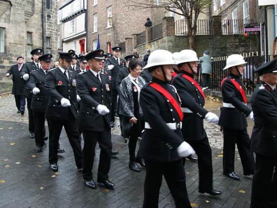 The combined fire service detachment on parade in Durham at a previous Remembrance Day event.