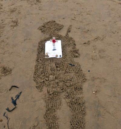 Members of the public made their own soldiers in the sand
