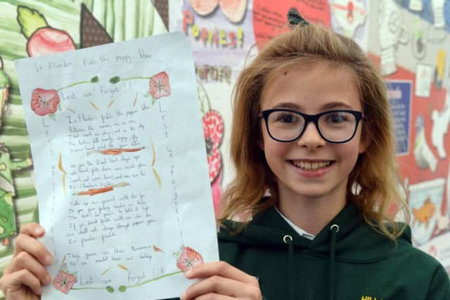 Hill View Junior youngster, Poppy Tomlinson, with her poem.