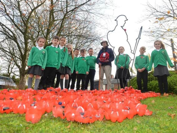 West Rainton Primary School pupils's surprise poppy display at nearby Springfield Lodge Care Home. Alongside them is home resident veteran air gunner Tom Douglas.