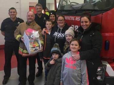 Southwick residents hand over a hamper to the crew of Marley Park Fire Station. Photo by Tyne and Wear Fire and Rescue Service.
