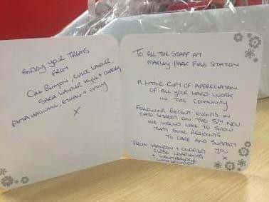 The card handed to the firefighters from residents.
