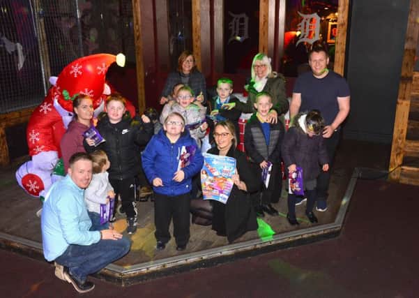Sunderland Echo Toy Appeal 2018 with Illusions Nightclub manager Mark Heptop, left, and Hope 4 Kidz Shannon Crowder with children from Sunningdale School.