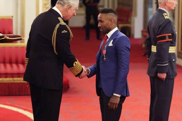 Former Sunderland striker Jermain Defoe is presented with the OBE he was awarded in the Queen's birthday honours list by the Prince of Wales at Buckingham Palace. Pic: Jonathan Brady/PA Wire.