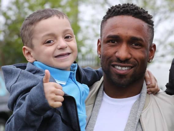 Jermain Defoe recalled his 'amazing' memories of little fighter Bradley Lowery as he picked up his OBE today.