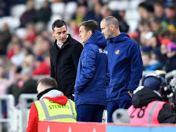Jack Ross in discussion with his backroom staff