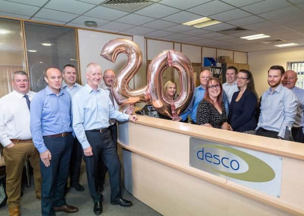Staff at Desco celebrate the firm's 20th anniversary.