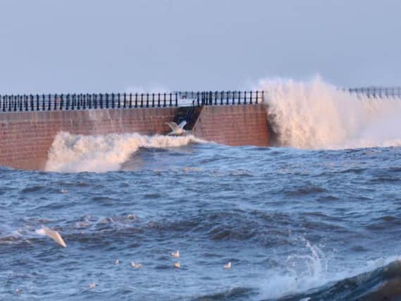 Waves crash against Roker Pier today