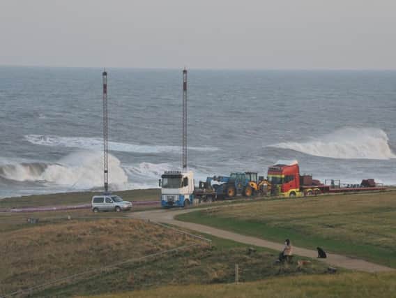 Teams putting up a tent for filming on the Leas near to Souter Lighthouse.