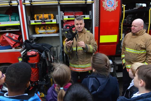 Firefighters visit St Patrick's RC Primary School following school charity clothing collection.