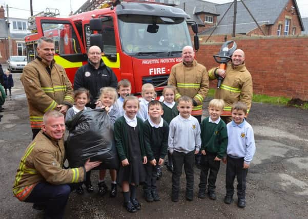 Firefighters visit St Patrick's RC Primary School following school charity clothing collection with crew manager Martin Abbott.