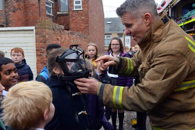 Firefighters visit St Patrick's RC Primary School following school charity clothing collection.
