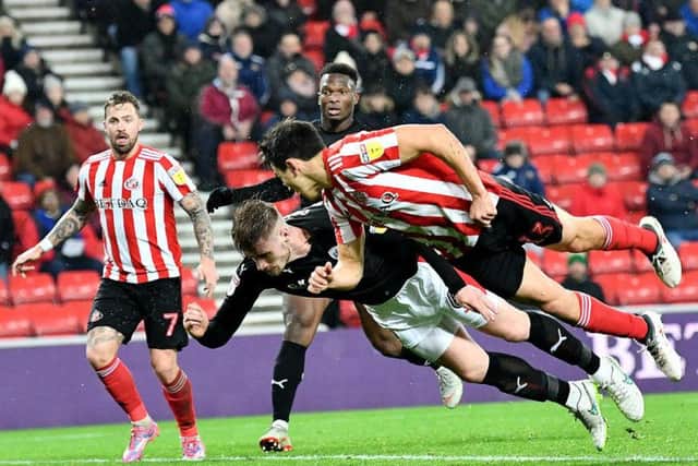 Luke O'Nien makes a diving header in the 4-2 win over Barnsley.