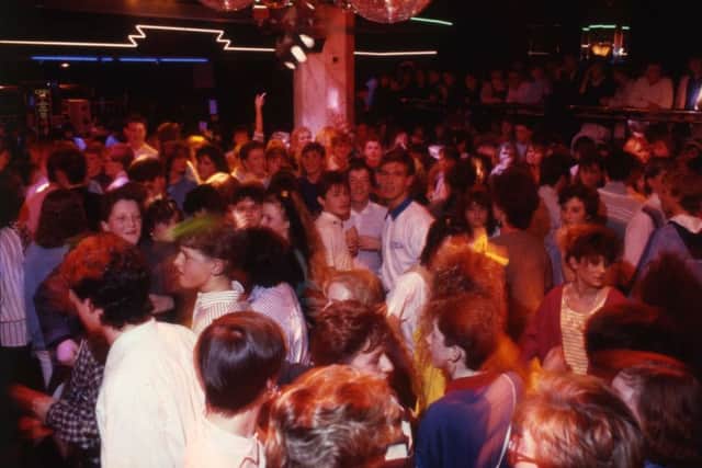 The packed dance floor at the night for teenagers.