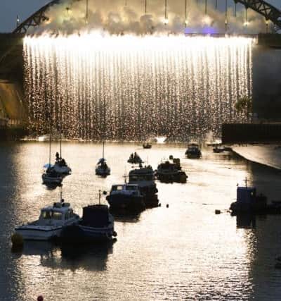 A curtain of light falls from Wearmouth Bridge as part of the Tall Ships Races event