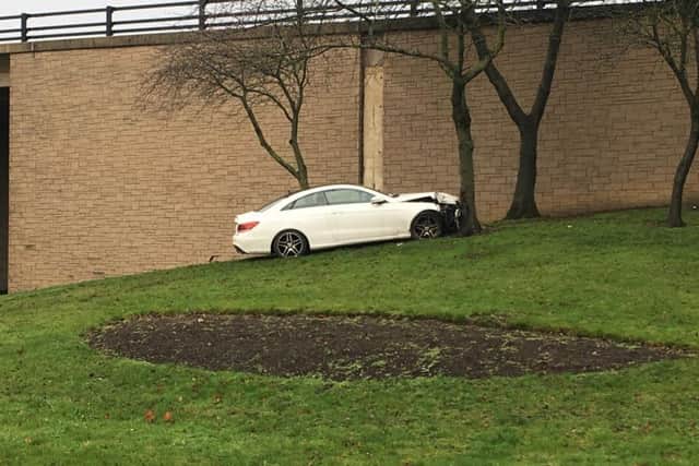 A white Mercedes which has crashed into a tree on a roundabout in Houghton.