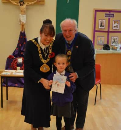St Joseph's RC Primary School pupil Lilia Dobbing with her winning Christmas card design alongside Mayor of Sunderland Lynda Scanlan and mayoral consort Micky Horswill.