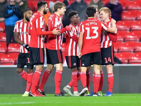 Sunderland players celebrate the first goal.