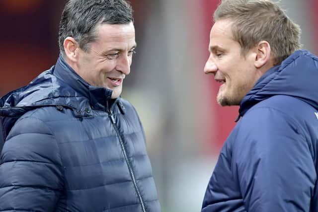 Sunderland boss Jack Ross in conversation with Neal Ardley.