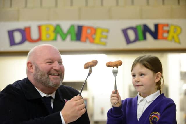 Jamie Freeman of Freeman Catering Butchers, sponsors of the event, and Paige Simpson with her winning sausage.