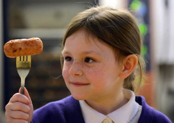 Dubmire Academy pupil Paige Simpson, six, with her Kicking Chicken sausage, winner of  regional sausage schools competition.