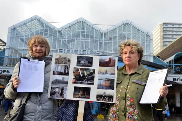 Susan Mulvaney and Denise Craig with their petition which campaigned to save the organ at Holy Trinity Church.