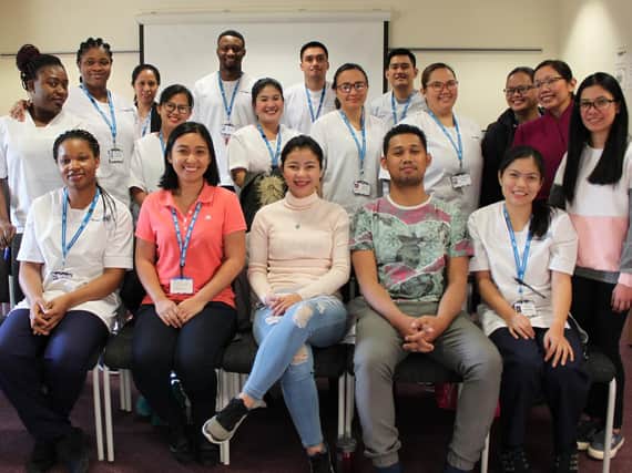 Three of South Tyneside and City Hospitals Sunderland NHS Foundation Trusts newest recruits from The Philippines, Carrie Bernasor, Erlinger Navos and Janice Tingson, seated centre, with some of the Trusts other overseas recruits