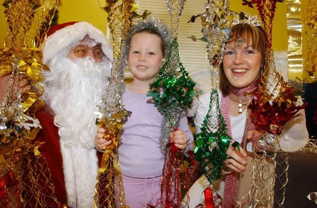 Megan McIntosh meets Santa in 2004 at St Mary's Childcare Centre.