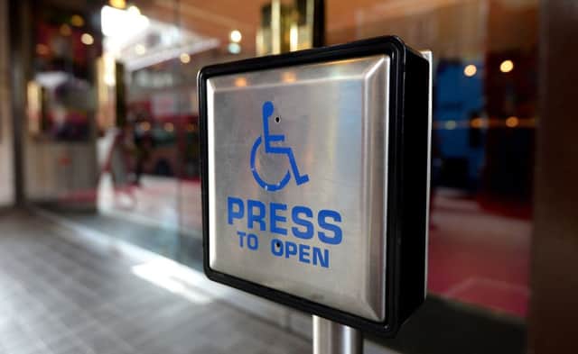 A disabled entrance door button. Picture by PA Wire/PA Images