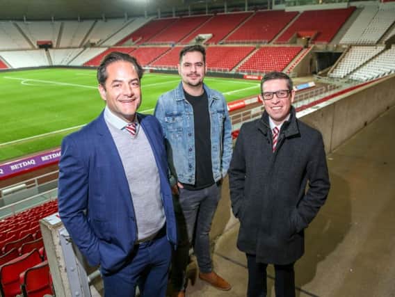 Charlie Methven (L) with Red & White Army Chairman Andrew Hird (C) and supporter liaison officer Chris Waters (R) in front of the newly-named 'Roker End'