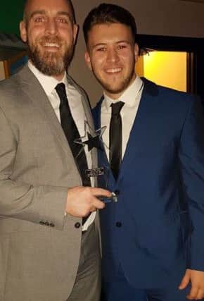 Stuart (left) and Liam Roper of Armageddon Fit Strength and Conditioning Academy with the Combat Zone Gym of the Year award.