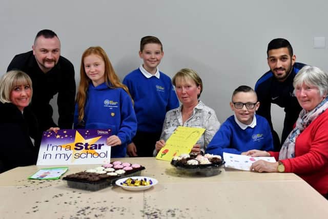 New Silksworth Academy support staff (left to right) Mandy Hodgen, John Peters, Gillian Crawford, Amarettos Purewal and Edna Parkin with pupils (left to right) Ebony Page, Jack Gettings and Charlie Pearson, enjoying the tea party after the Stars in Their Eyes presentation held at the school