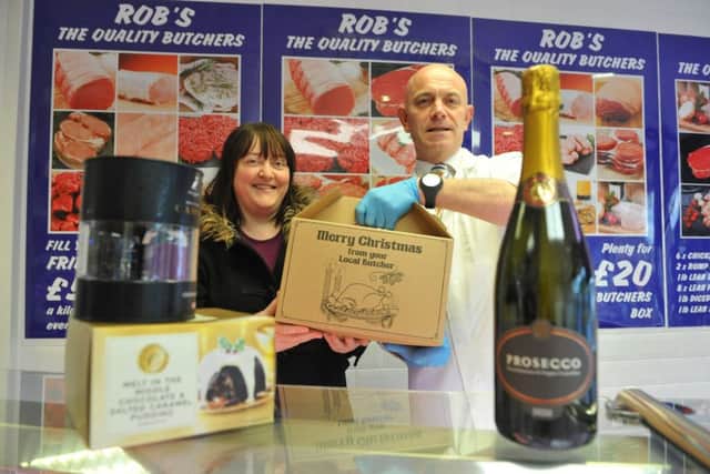 Food hamper prize draw winner Linda Wilkinson receives her prize from butcher Rob Robson.