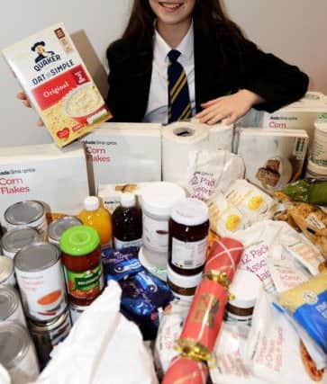 Hetton School pupil Jasmine Smith with items of food the school collected in aid of the foodbank.