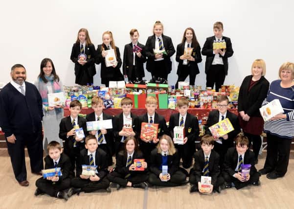 Hetton School staff Amran Suleman, Gloria Cairns, Megan Pigg and Louise Birctham and pupils with items of food that was collected in aid of the foodbank.