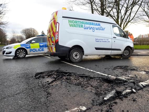 Police and Northumbrian Water vehicles at the scene of a burst water main in Sunderland.