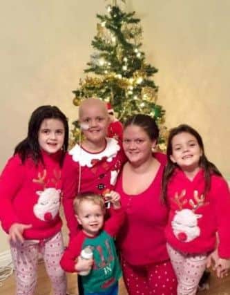 Sophie Laidler with her sisters, step brother and mum Nicola around the Christmas tree.