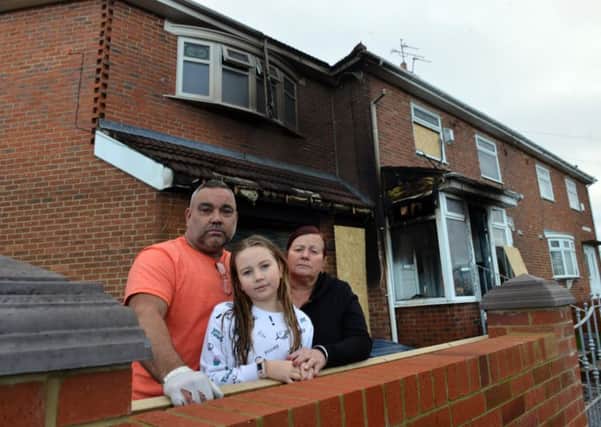 Paul and Lynda Russell with grandaughter Millie Pearson at their Portchester Road home the day after the fire.