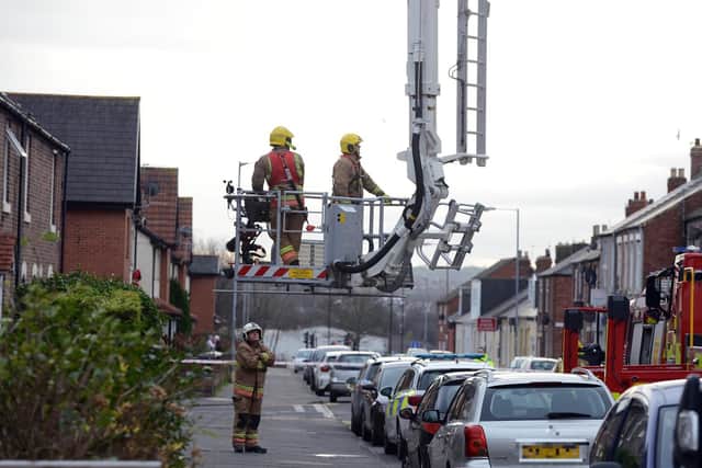 Fire crews prepare to deal with a loose chimney in Carley Road, Sunderland.