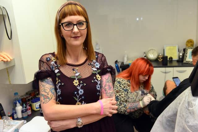 Sarah Wilkinson who has recovered from cervical cancer has a number of tattoos decorating her scars from surgery.