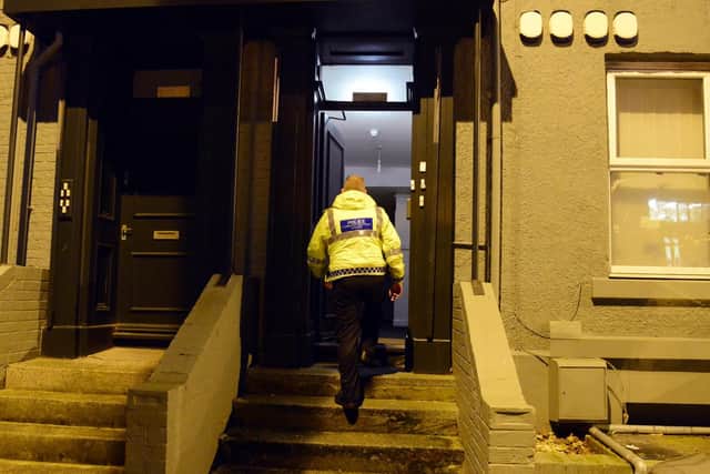 Police at the address following the discovery of a cannabis farm on Friday.