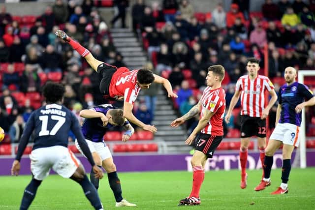 Luke O'Nien takes a tumble in the draw with Luton Town.