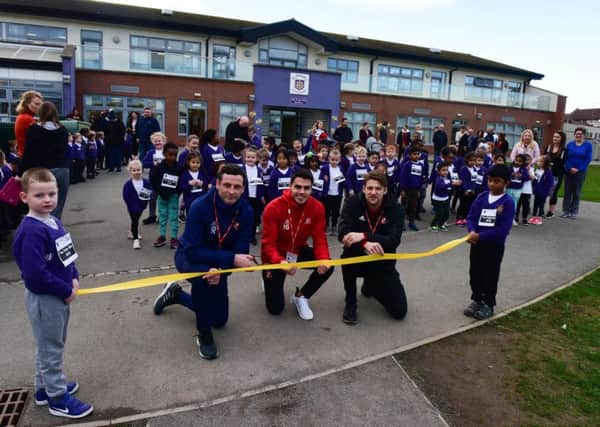SAFC manager Jack Ross with players Reece James and Glenn Loovens during their visit to St Joseph's RC Primary School, Rutland Street, Sunderland, to launch the school's Daily Mile track.