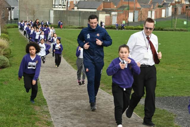 Jack Ross running with pupils and staff at St Joseph's RC Primary School.