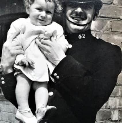 Bill in his younger days, holding his son George.