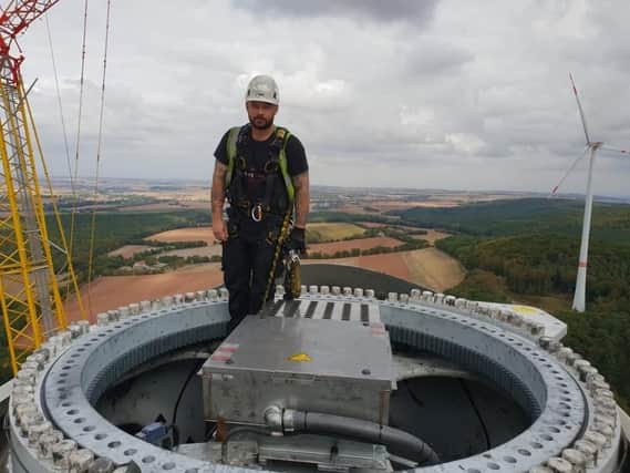 Ricky Christie working at the top of a wind turbine in Germany.
