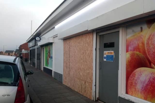 The front of the store is boarded up this morning