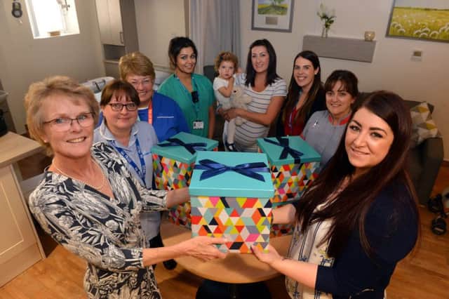 Sunderland Royal Hospital Maternity department consultant Helen Cameron, left, receives donation boxes from Steph Archbold, front right.