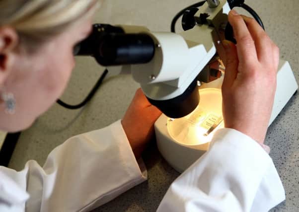 Checking for cervical cancer under a microscope. Picture by PA Archive/PA Images