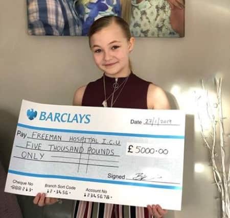 Brooke Priest with a cheque for £5,000 for the Freeman Hospital in memory of her mum Becky Timby.